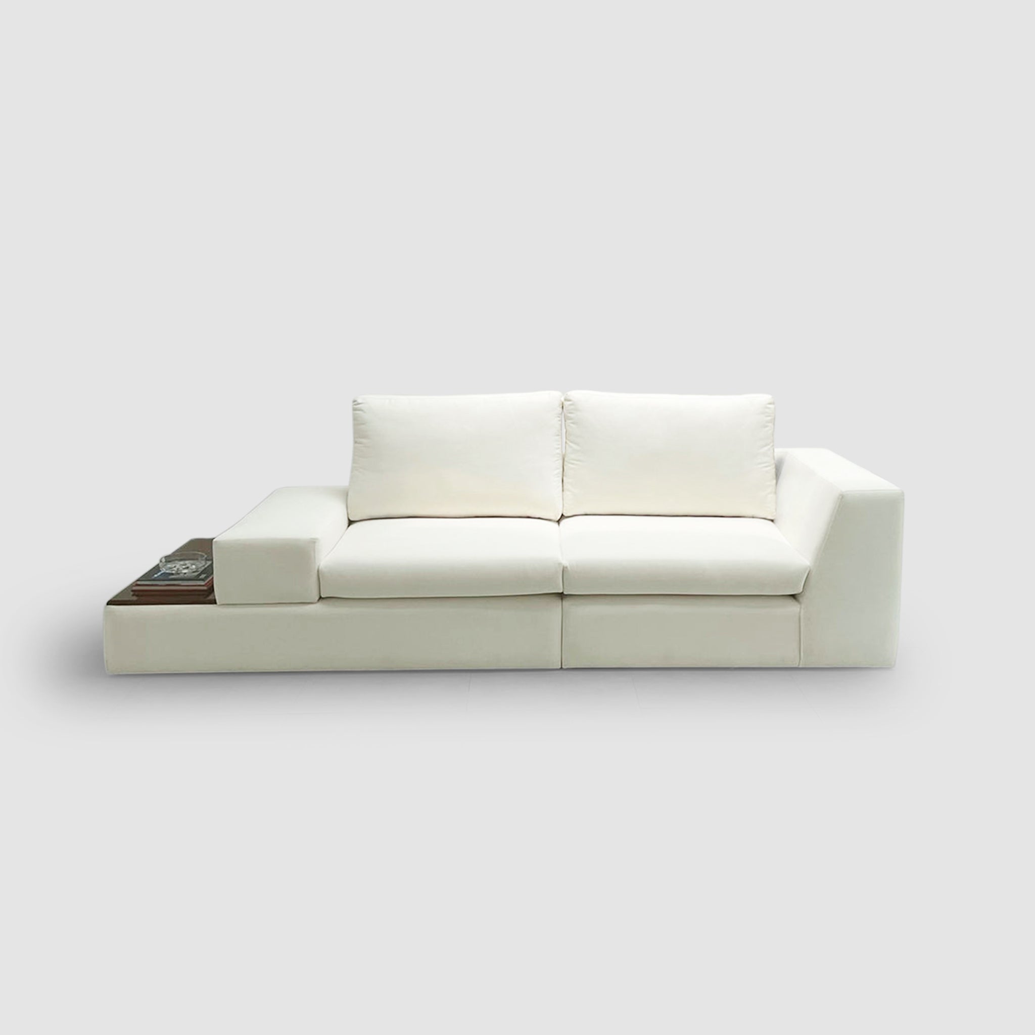 Modern white sofa with built-in side table, offering both comfort and functionality for a contemporary living room.
