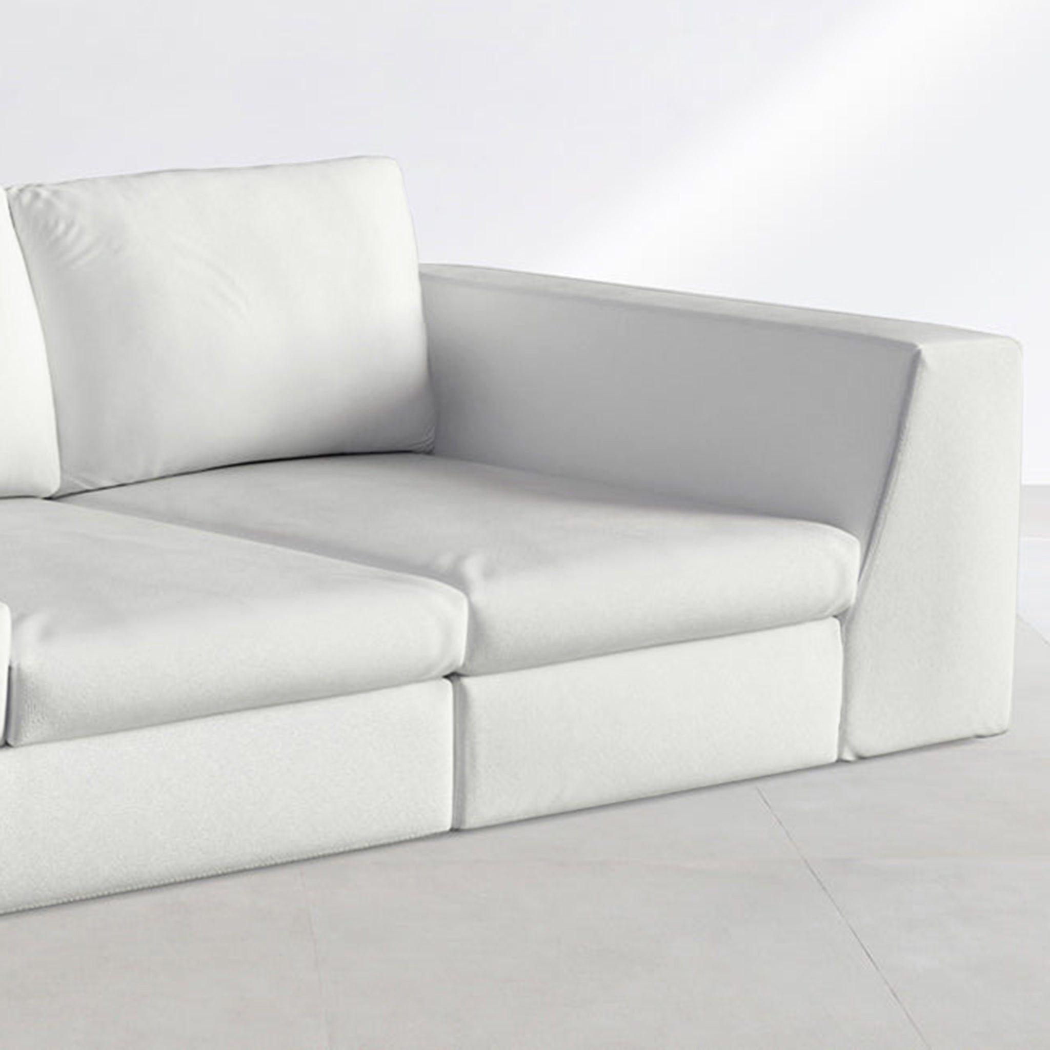 Close-up view of a white sofa featuring a cylindrical bolster pillow, highlighting the soft and luxurious fabric for a contemporary living room.
