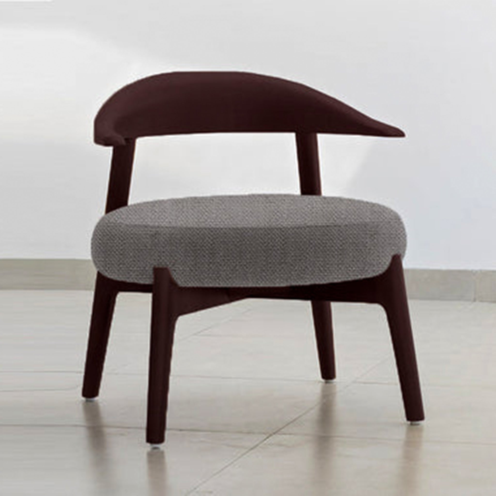 "The Hyde Accent Chair with a sleek wooden frame and cozy fabric seat"