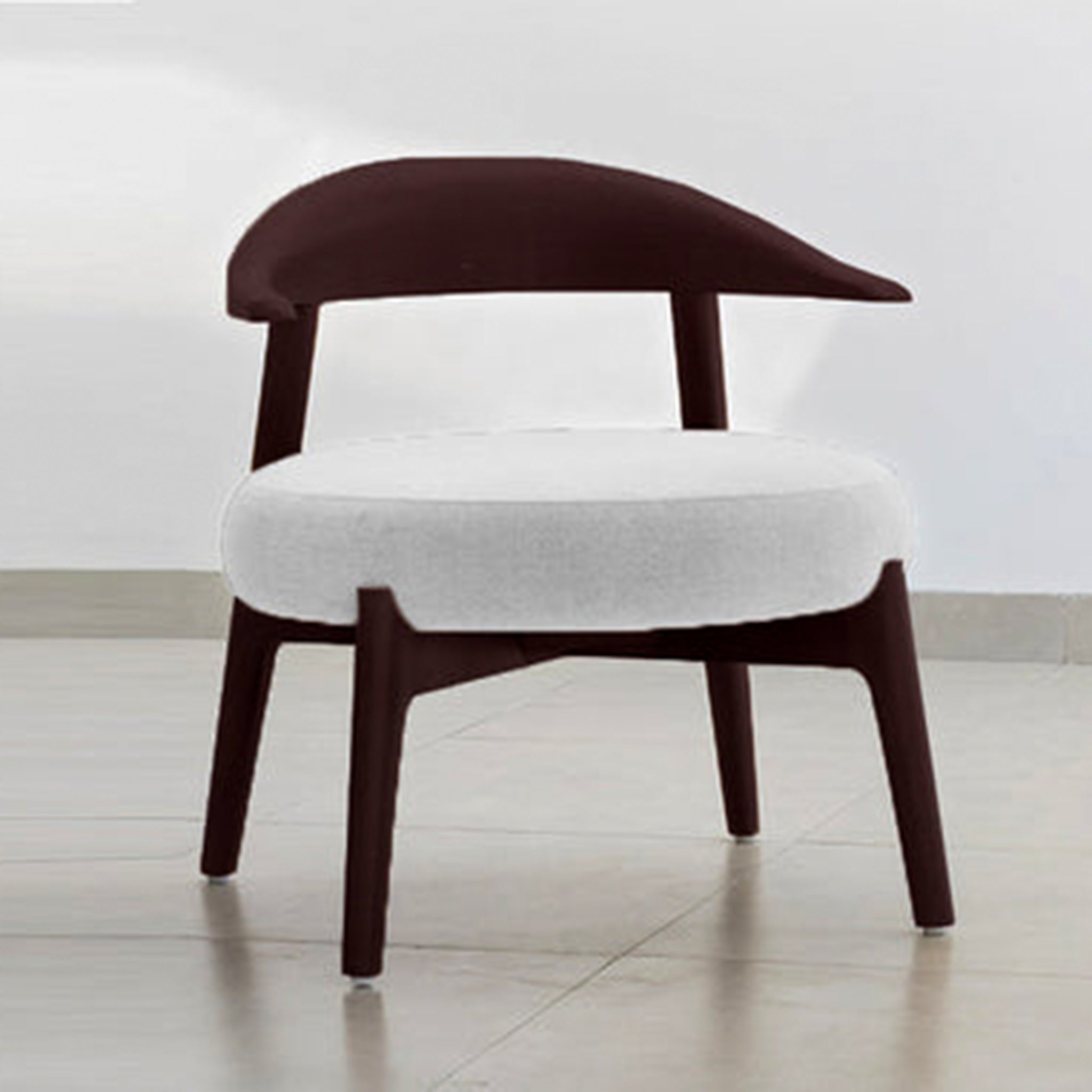 "The Hyde Accent Chair with a unique wooden frame and round cushioned seat"