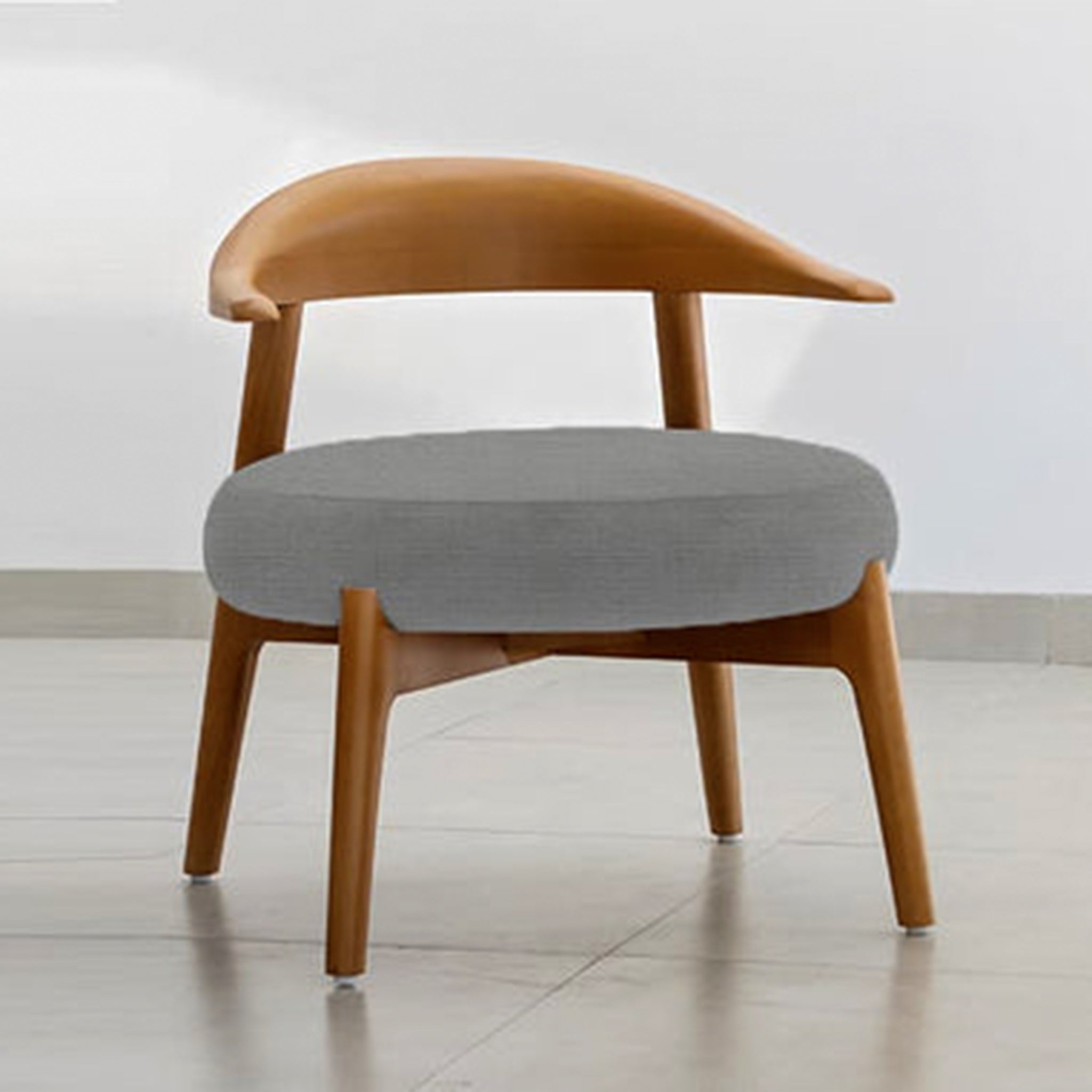 "The Hyde Accent Chair's curved wooden back and plush seating"