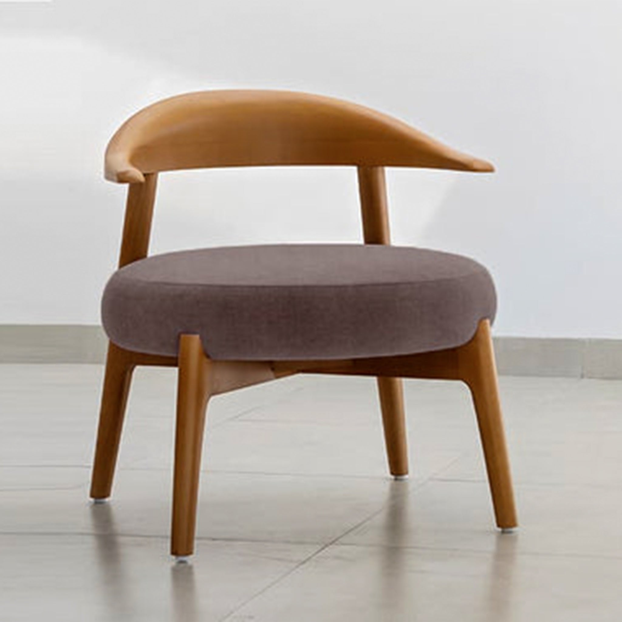 "The Hyde Accent Chair with sleek wooden backrest and cushioned seat"