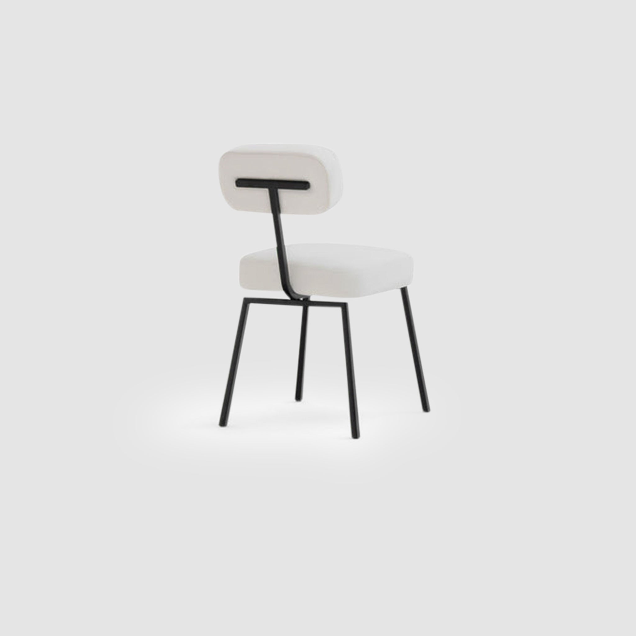 The Ida Dining Chair - modern upholstered dining chair with a black steel frame, cushioned seat, and backrest, featuring a minimalist and contemporary design.