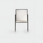 Load image into Gallery viewer, Elegant dining chair with iron legs, perfectly complementing a glass-top table in a contemporary setting.
