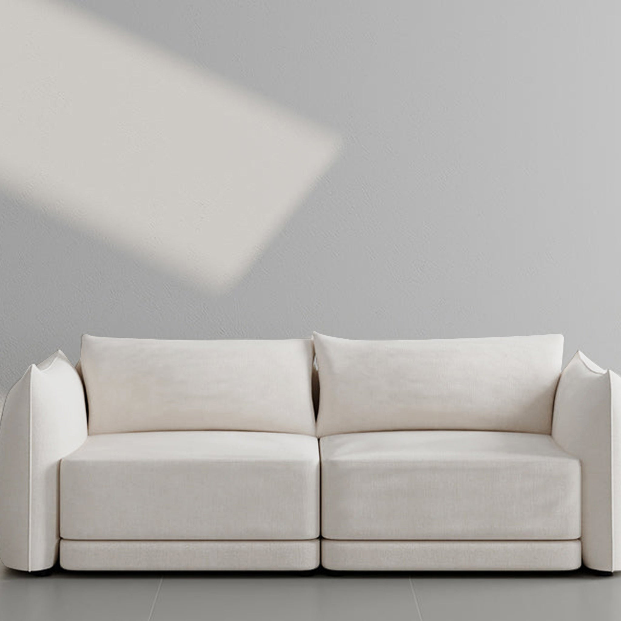 Modern two-seater white sofa with plush cushions and a sleek design, ideal for contemporary living spaces.