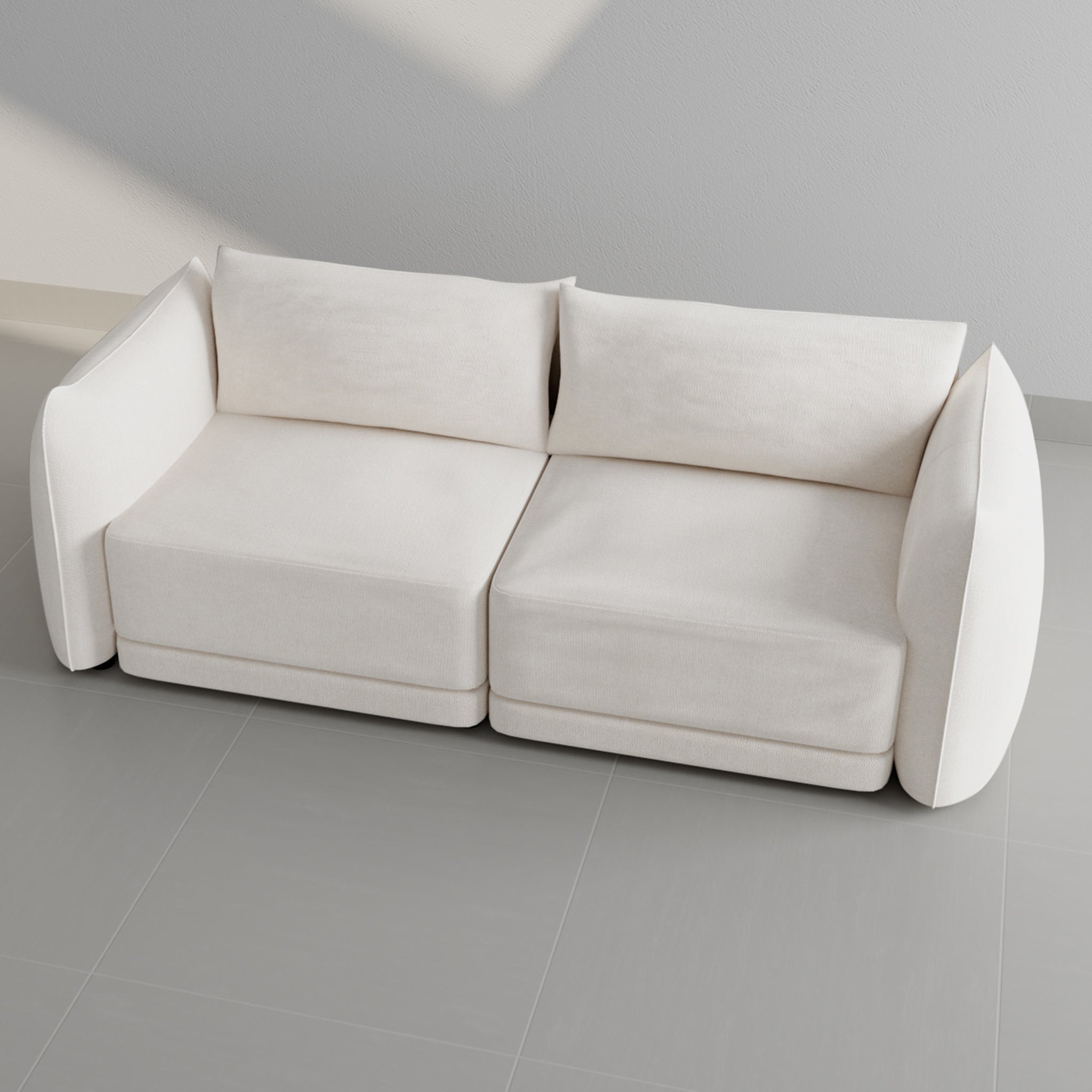 Top view of a modern white sofa with a minimalist design against a gray tiled floor, showcasing its clean lines and elegant structure.