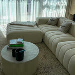 Load image into Gallery viewer, White couch and ottoman set in a living room with a framed picture of a staircase above. The couch and ottoman provide a comfortable and stylish seating area, while the picture adds a unique touch to the room. 4 Seater Sofa
