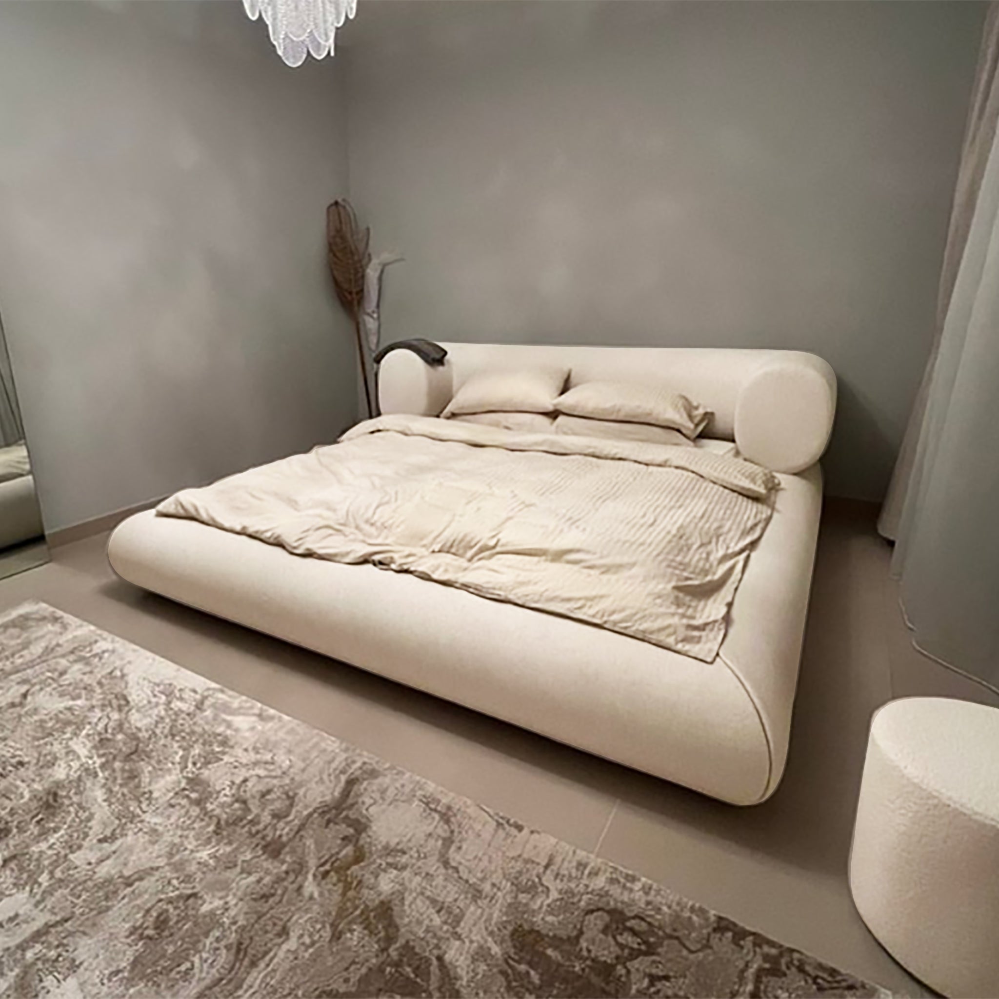 Elegant platform bed with a curved, button-tufted headboard in a bright and airy bedroom. The Lewis Bed by Klettkic offers a touch of modern luxury for a restful sleep experience.
