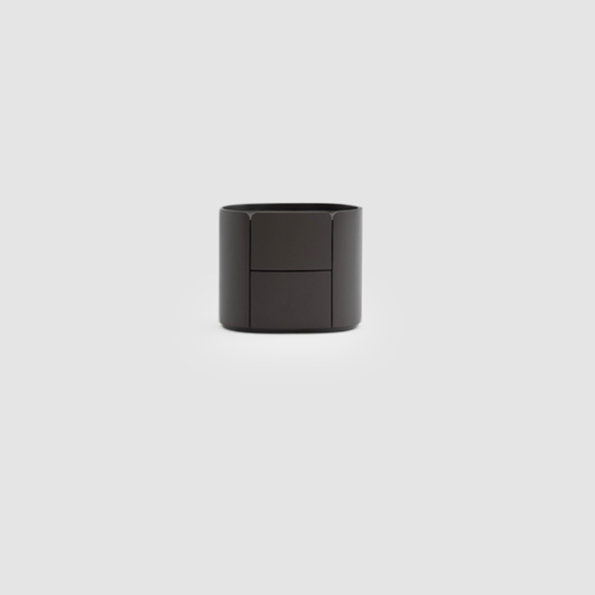 A sleek black bedside table with a cylindrical shape and two drawers, set against a plain light gray background.
