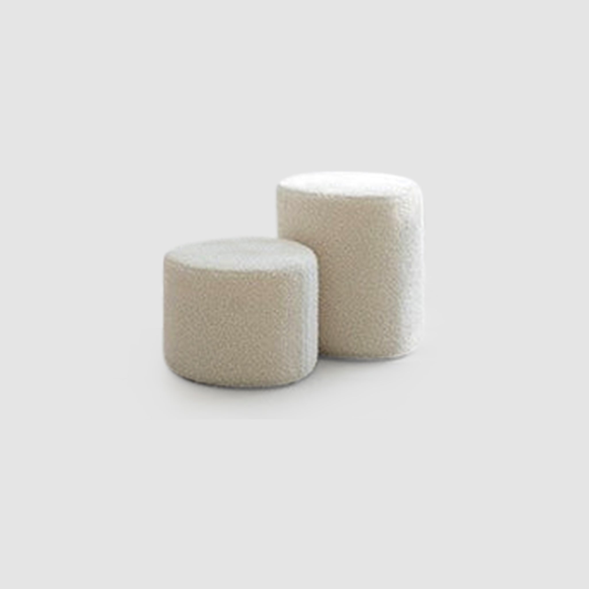 Two stacked white ottomans on a white background