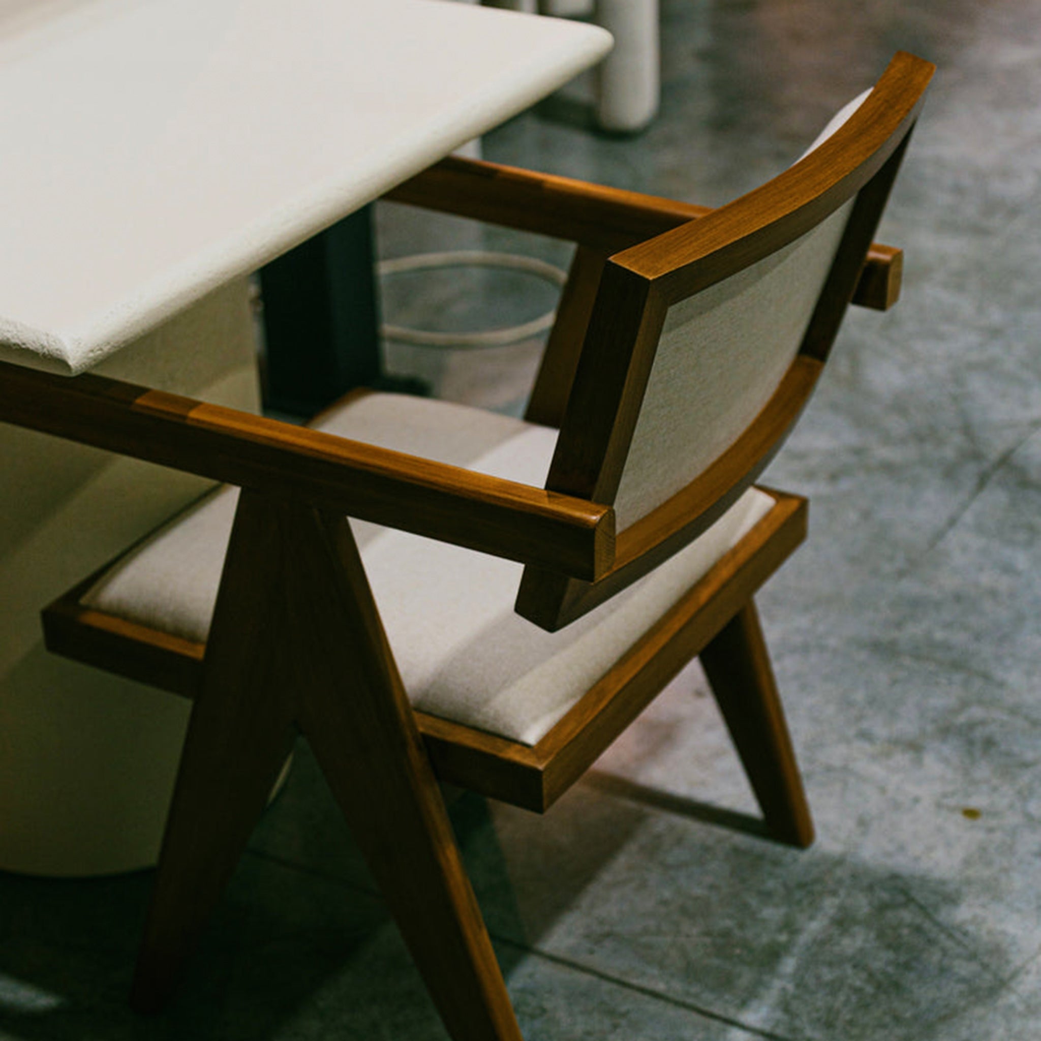 "The Pierre Dining Chair with beige upholstery and wooden structure."