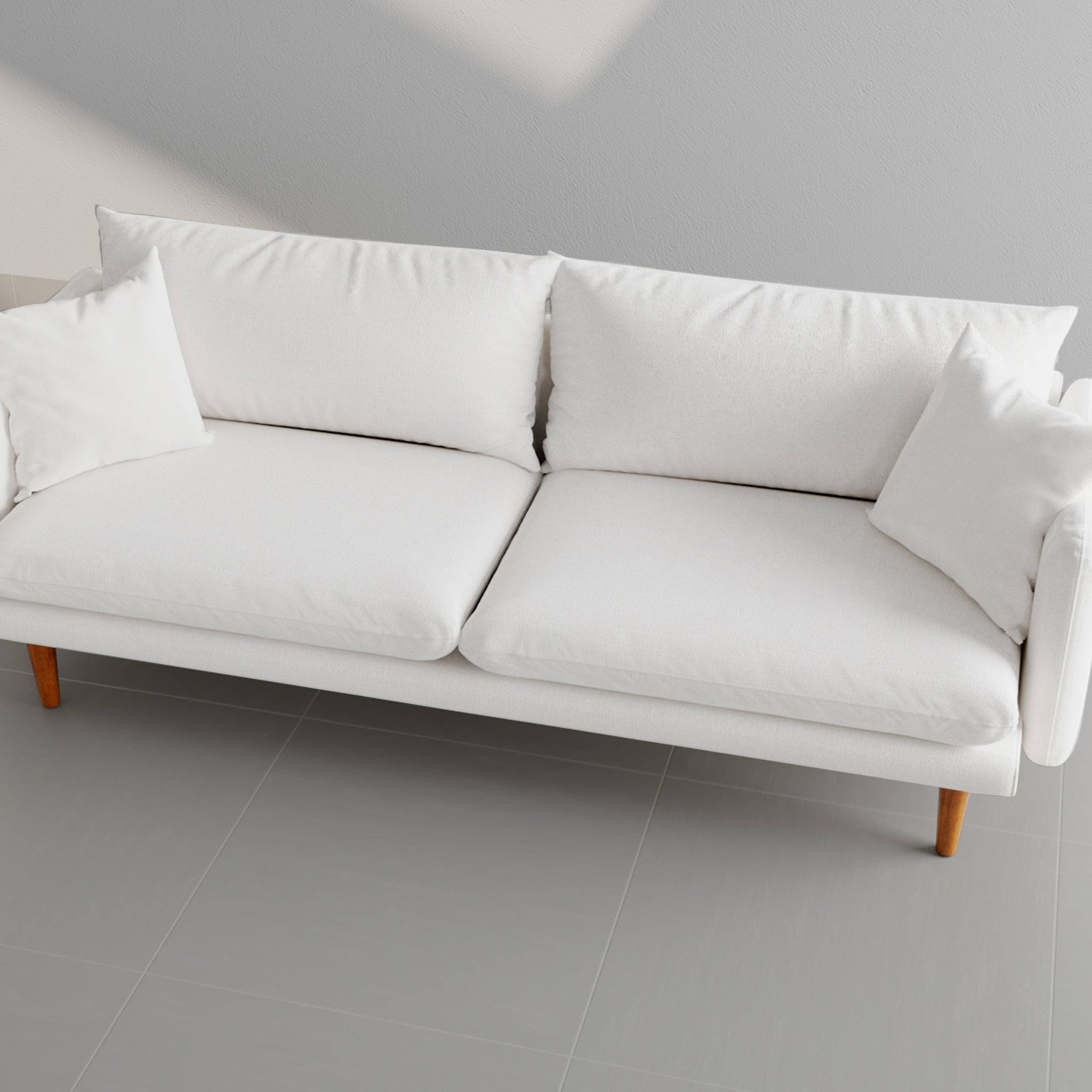 Top view of a sleek white sofa with soft cushions and wooden legs, ideal for modern living room decor.