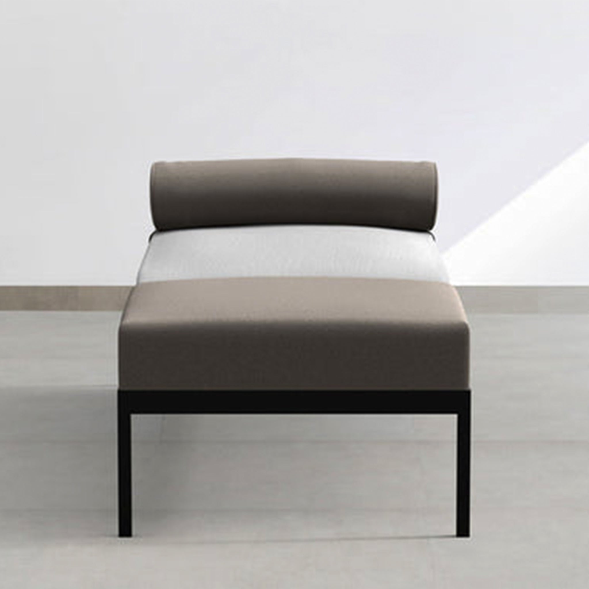 Front view of The Rodman Day Bed showcasing its classic midcentury design, powder-coated steel frame, and low seating. The daybed features two-tone upholstery with a Vegan Leather bolster cushion attached with Velcro.