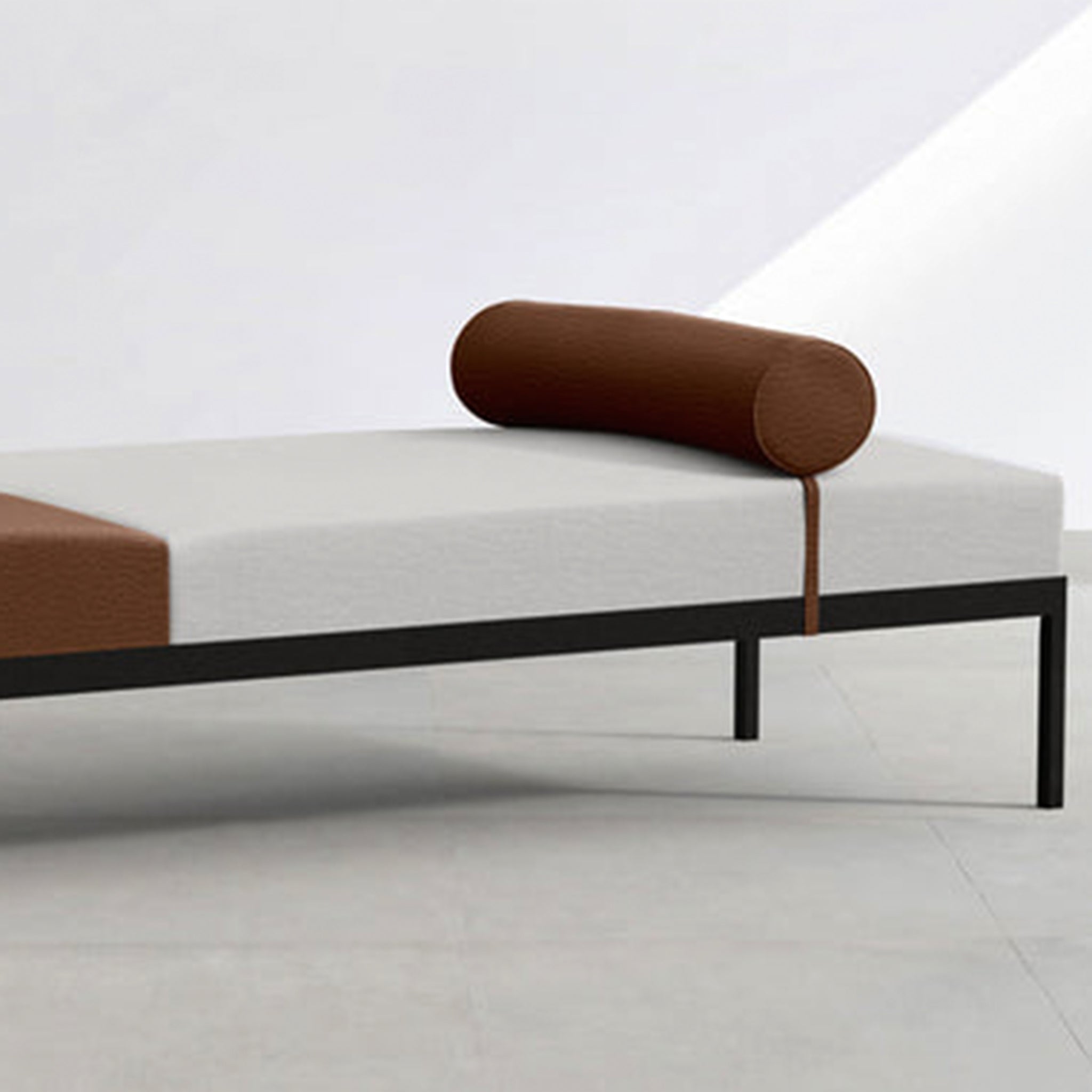 Two-tone upholstered Rodman Day Bed with bolster cushion.