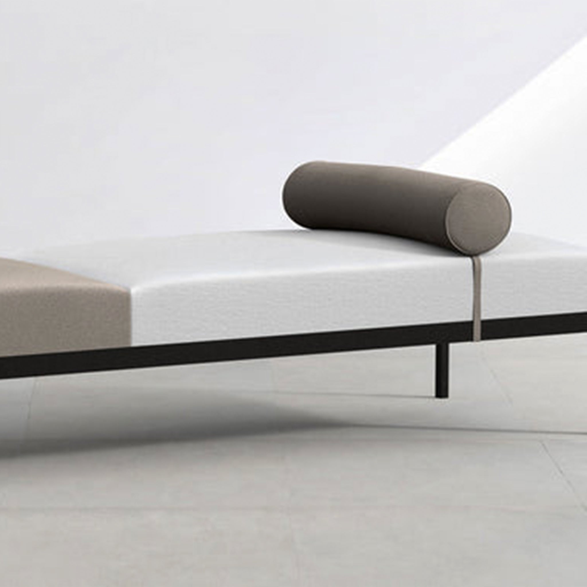The Rodman Day Bed featuring a vegan leather bolster cushion.