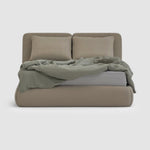 Load image into Gallery viewer, The Ruby Bed - fully upholstered bed with two bolster pillows and three oversized feather-filled cushions, showcasing elegant design and luxurious comfort in a modern bedroom setting. Bed buy dubai online

