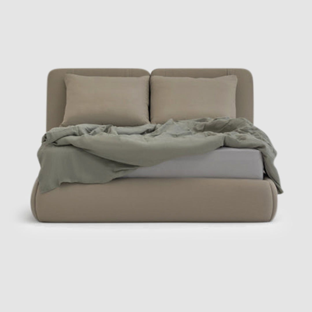 The Ruby Bed - fully upholstered bed with two bolster pillows and three oversized feather-filled cushions, showcasing elegant design and luxurious comfort in a modern bedroom setting. Bed buy dubai online