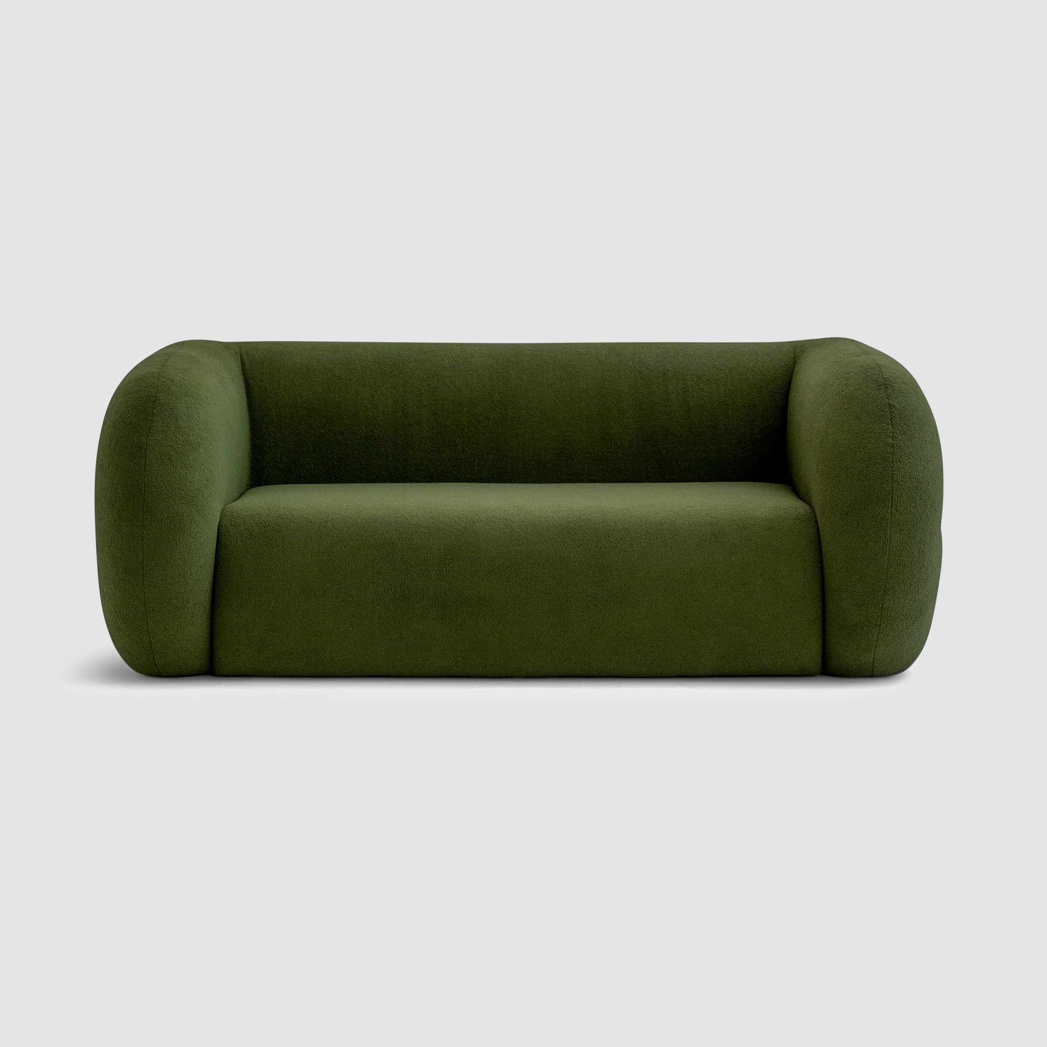 The Ruthie Sofa in green fabric, showcasing its unique, rounded design with curves, and a smooth back and sides that are as captivating as the front. The 2m sofa comfortably seats 2-3 people and features medium-soft cushions for ultimate comfort. buy a modern seating sofa