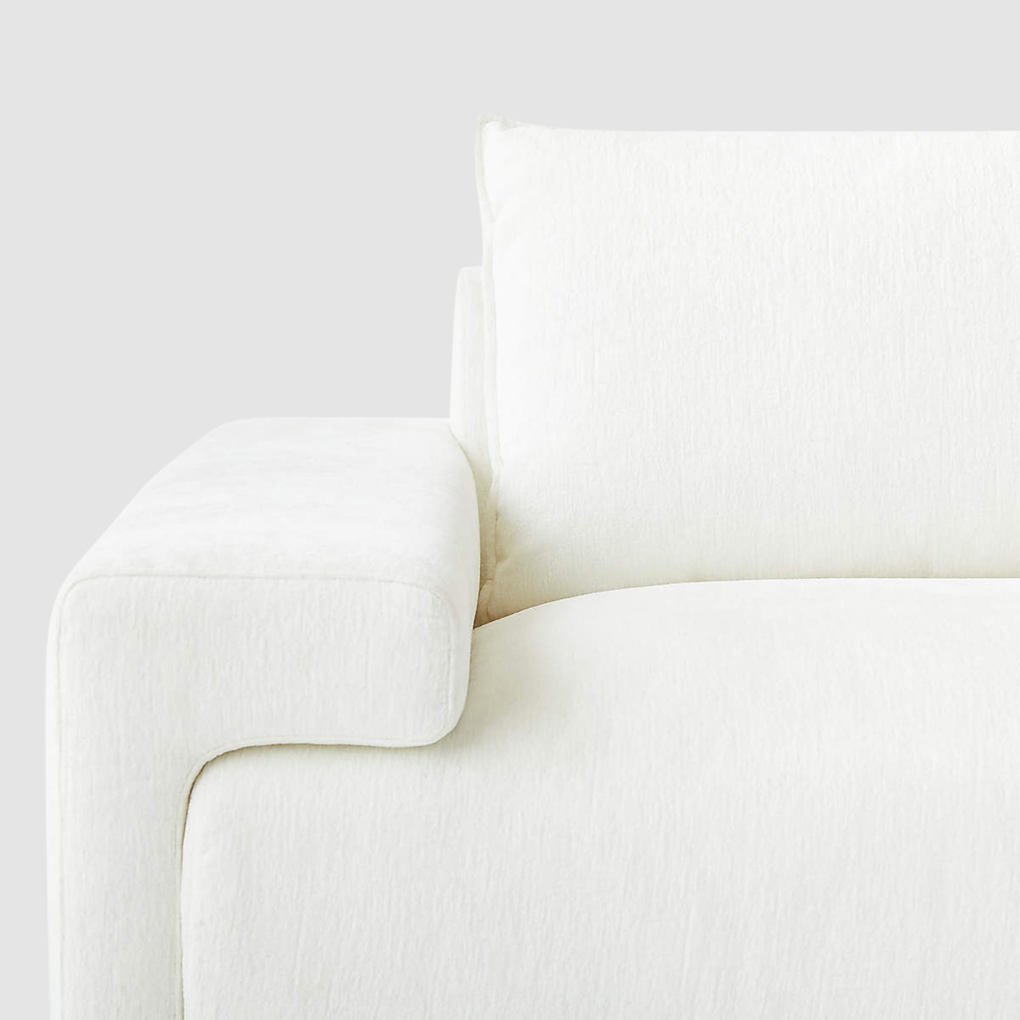 Buy Modern Sofas in Dubai - Close-up view of modern minimalist white Sylvia sofa armrest and cushion detailing, highlighting plush comfort and sleek design for a stylish living room