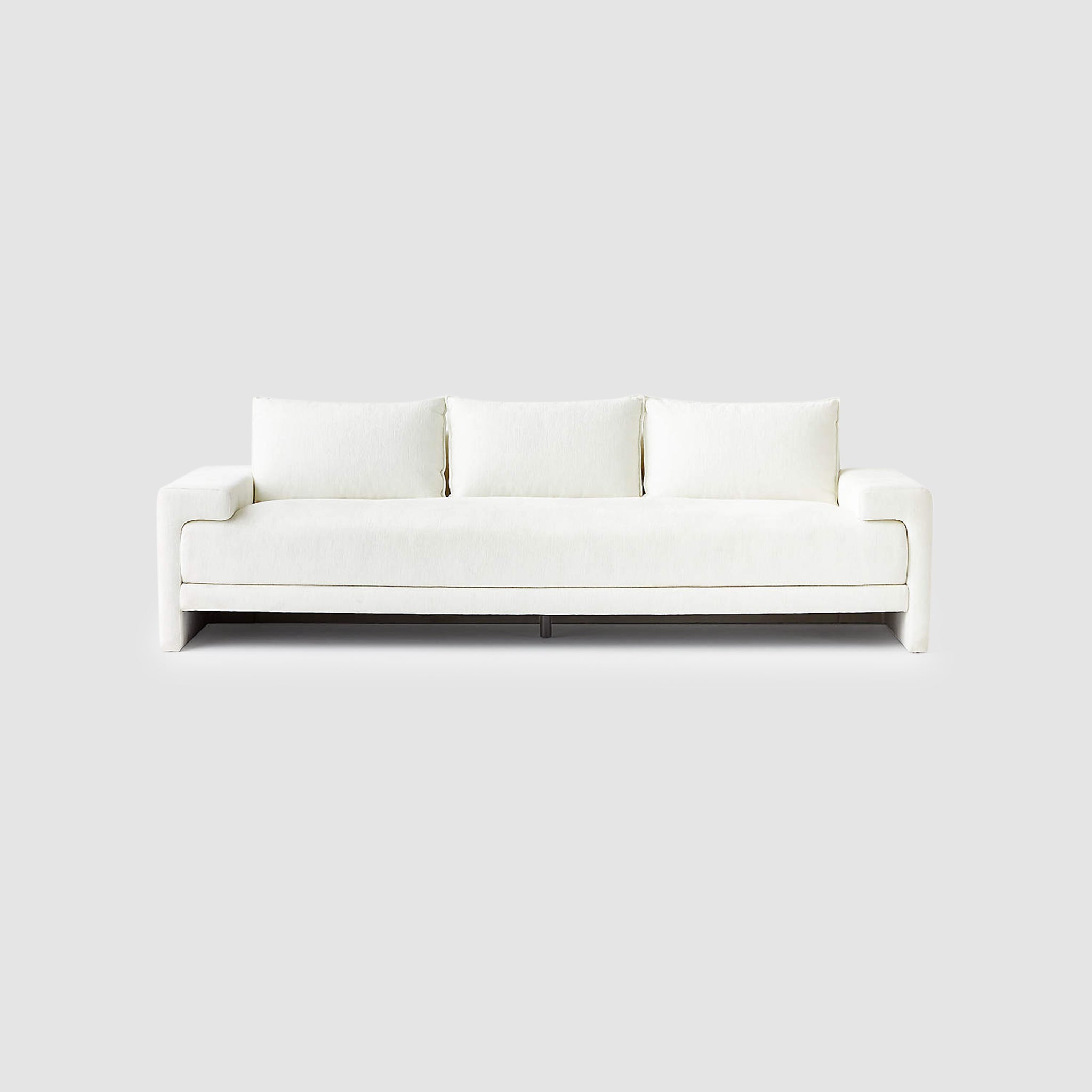 Modern white sofa with clean lines and plush cushions, front view - perfect for contemporary living rooms and minimalist interior design.