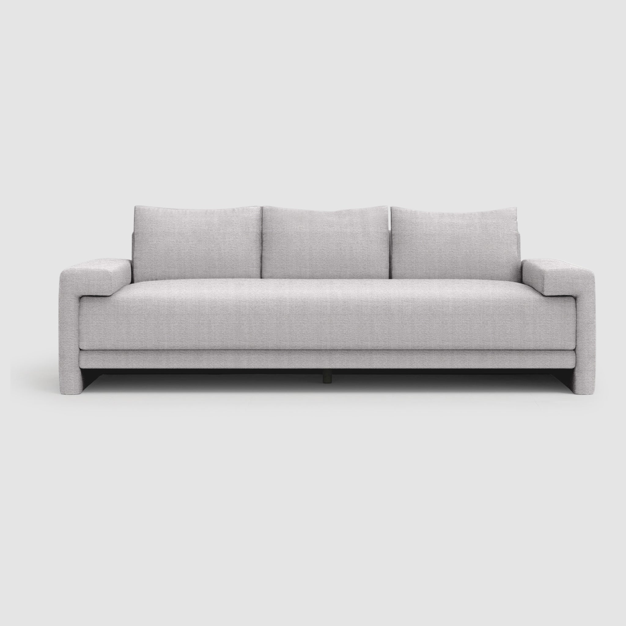 A modern sofa with three large back cushions and straight arms. The sofa sits on a lifted base with curved black steel legs.