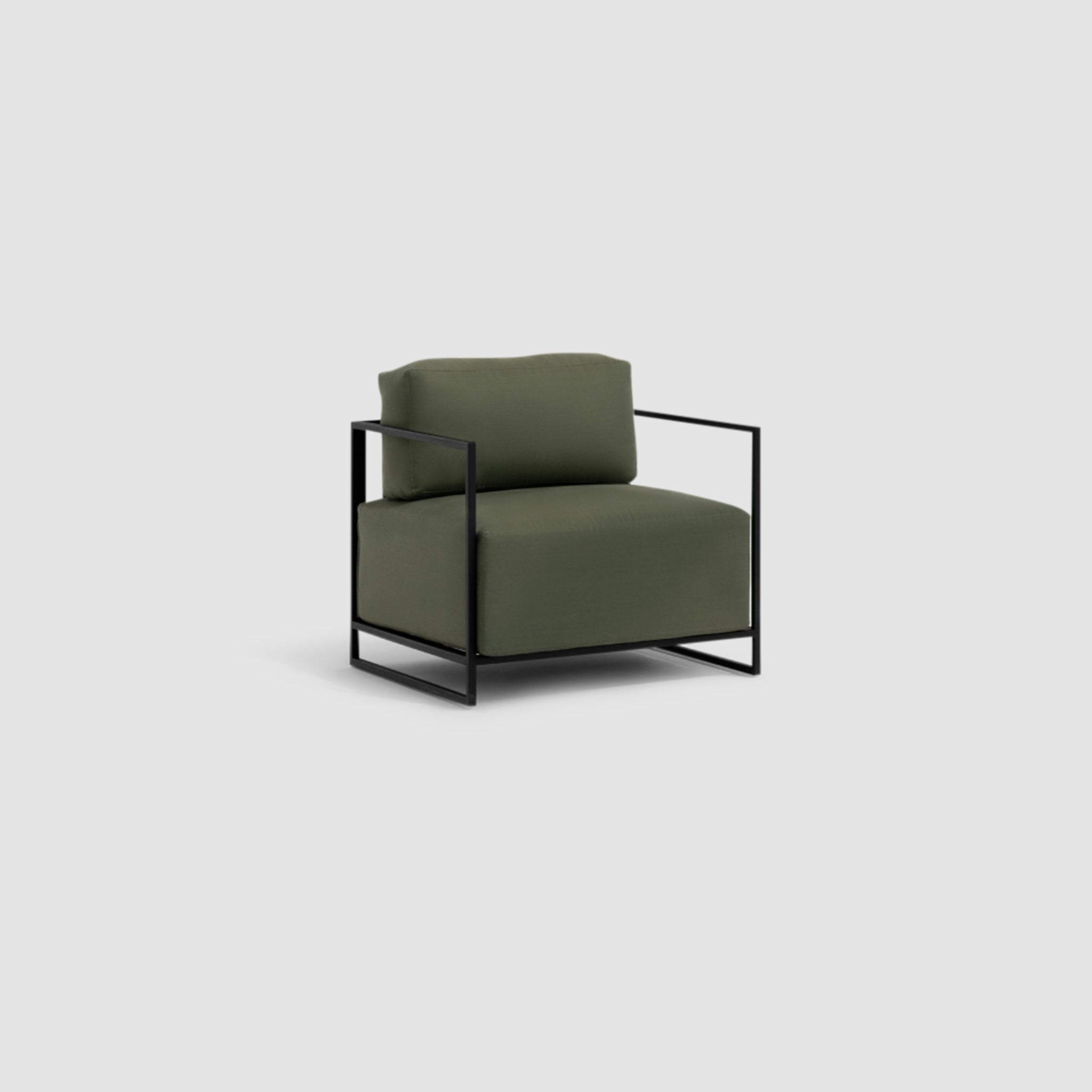 "Sophisticated side view of The Trevor Outdoor Modular Accent Chair featuring white upholstery and black metal frame, complemented by a beige table."