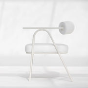 The Wanda dining chair in white, featured in a minimalist dining area, offering timeless charm.