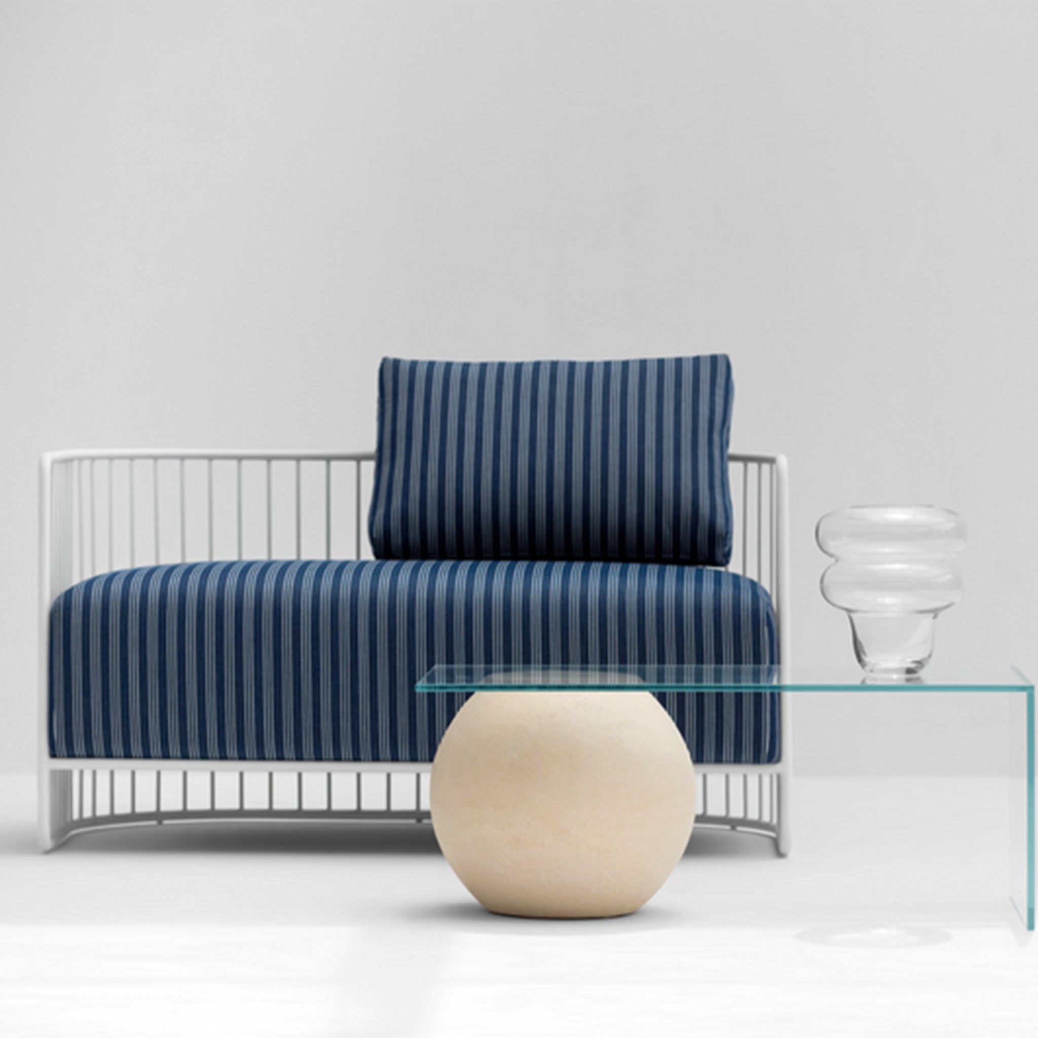 Front view of the Willa Outdoor Accent Chair showcasing its modern design with blue striped cushions and a white metal frame.