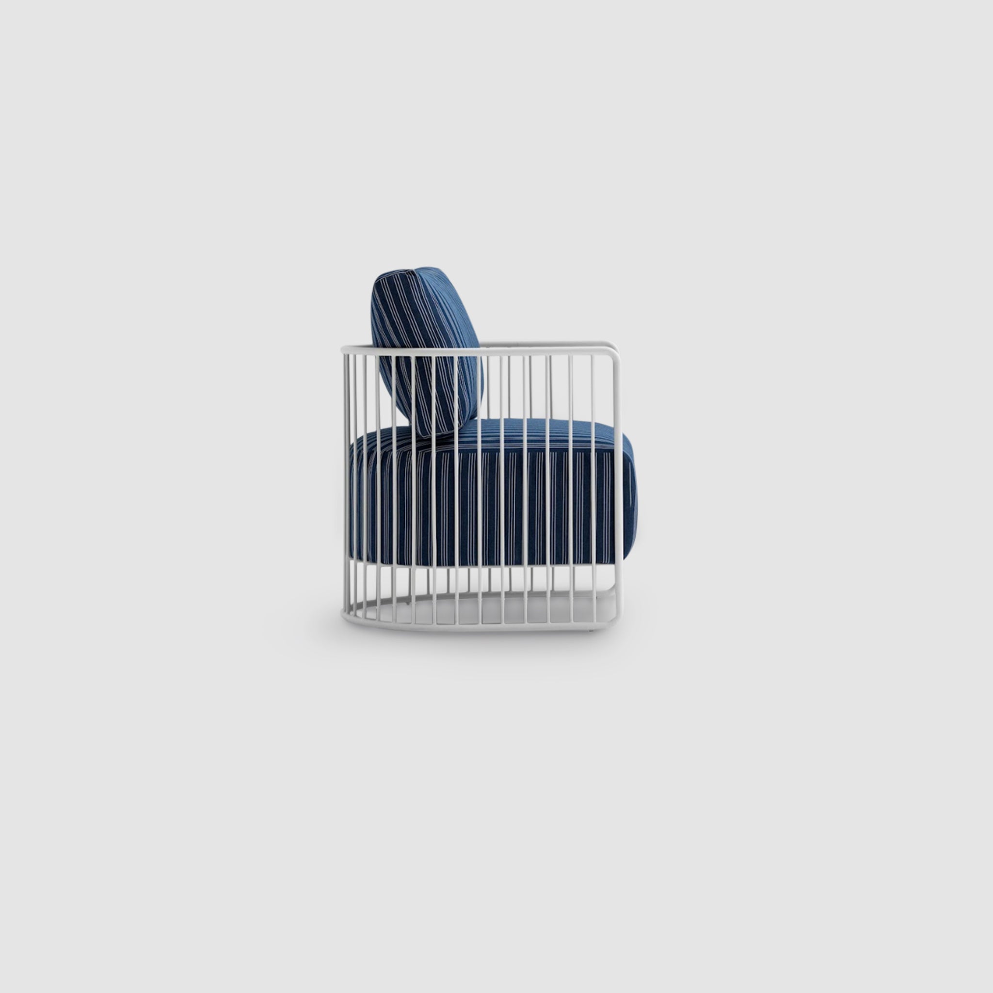 Side profile view of The Willa Outdoor Accent Chair featuring a modern white metal frame with plush blue cushions, designed for both style and comfort in outdoor settings.
