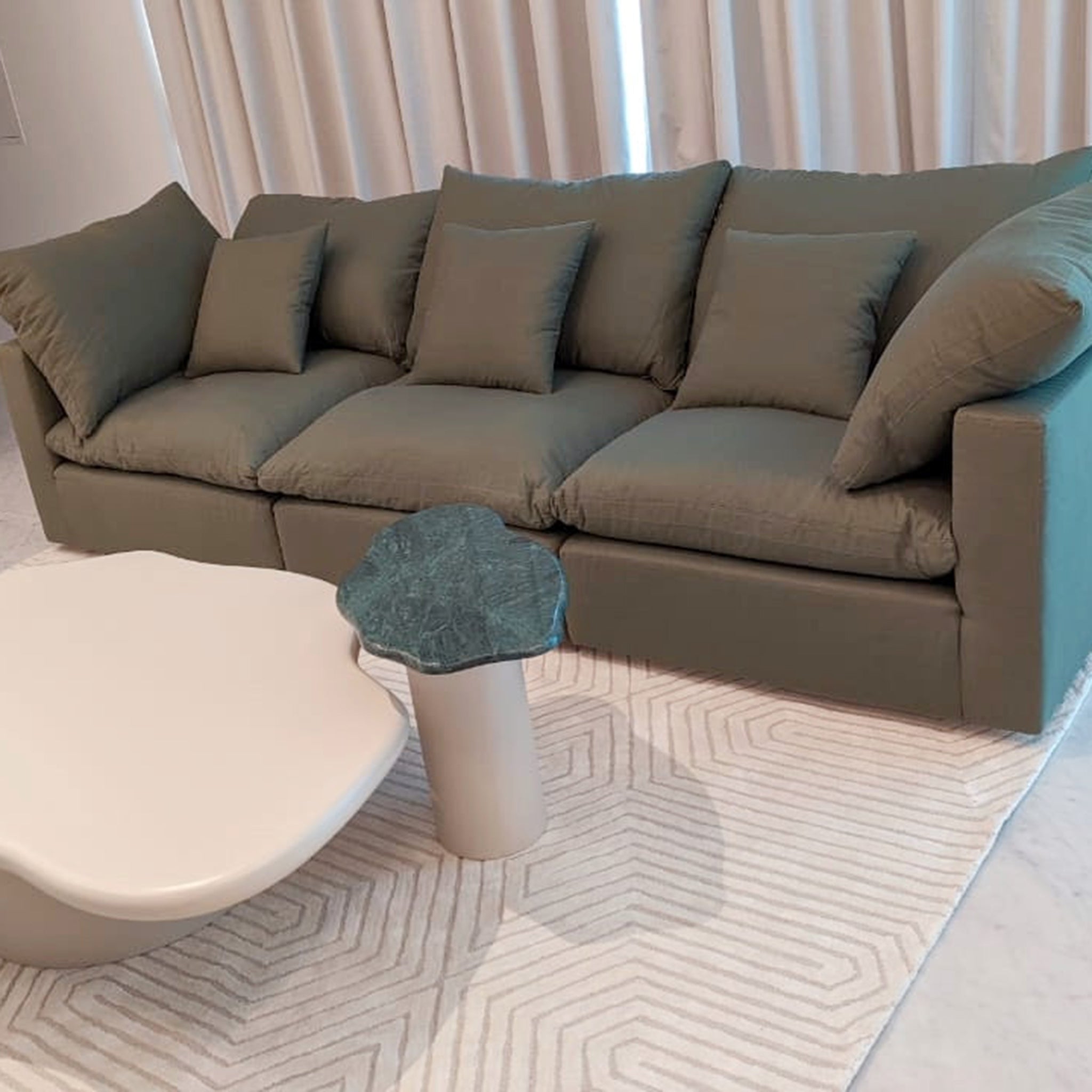 White curved sofa with a marble coffee table in a living room - Best cloud couch life style view