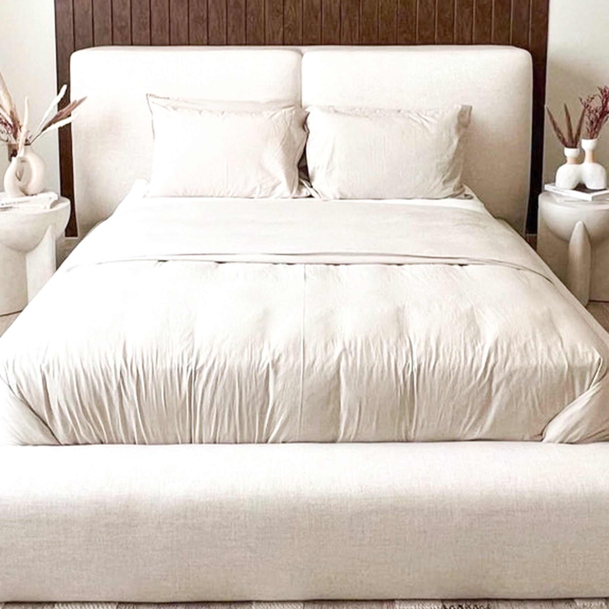 Modern white platform bed with woven storage baskets. Stylish and functional bedroom furniture.
