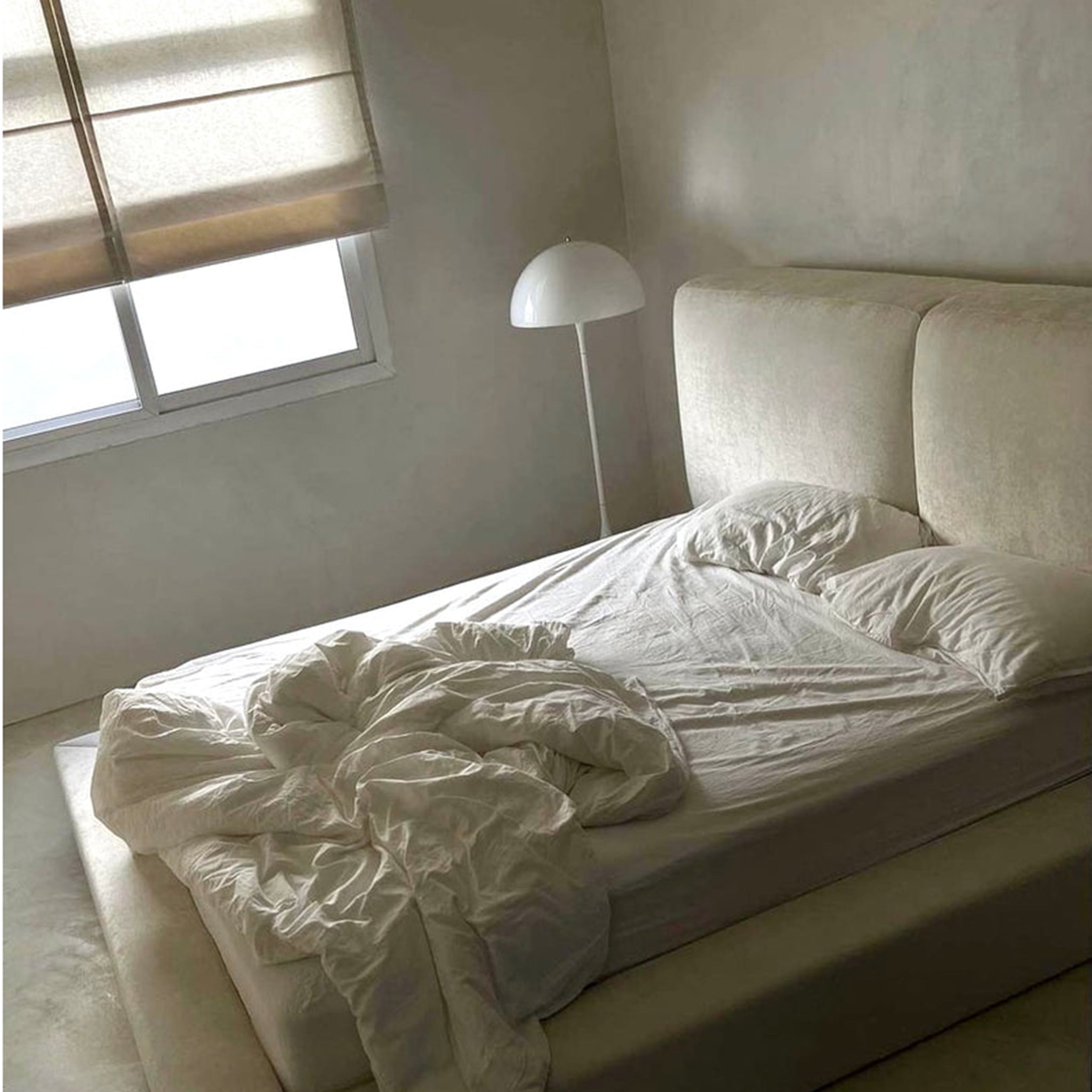 Light and airy bedroom corner featuring a cozy daybed. Perfect for reading, napping, or creating a relaxing seating area.