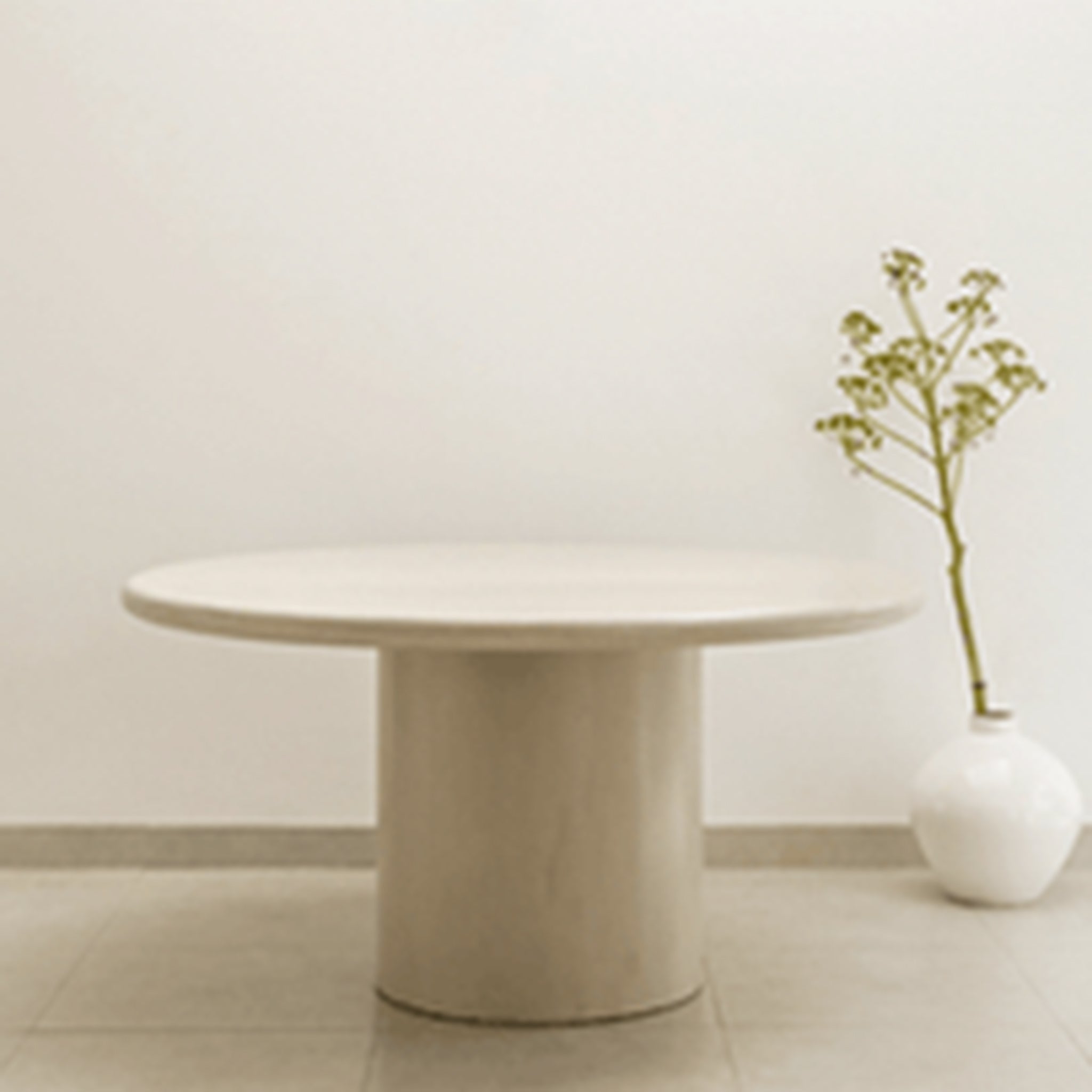Round dining table with a minimalist and clean aesthetic