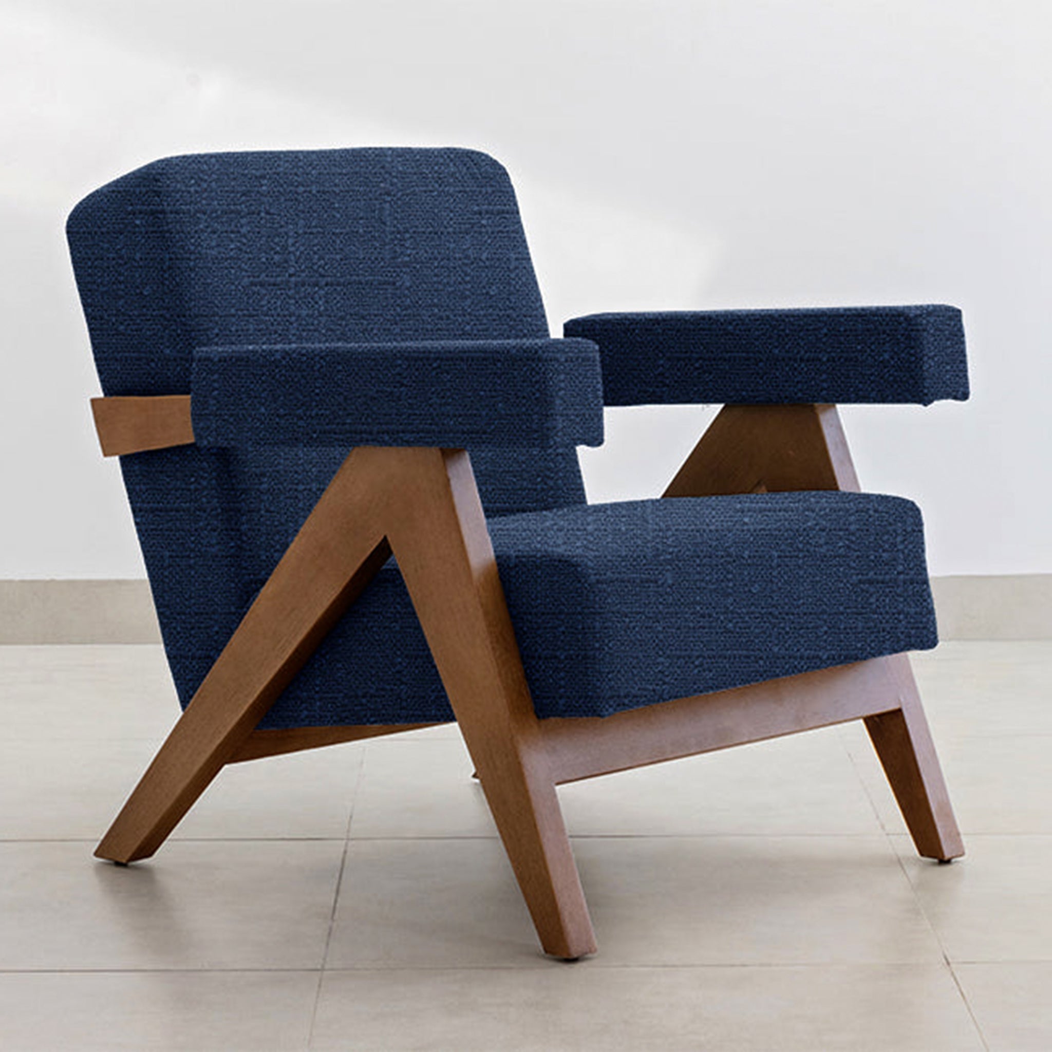 The Pierre Accent Chair featuring a blend of teal fabric and wooden frame.