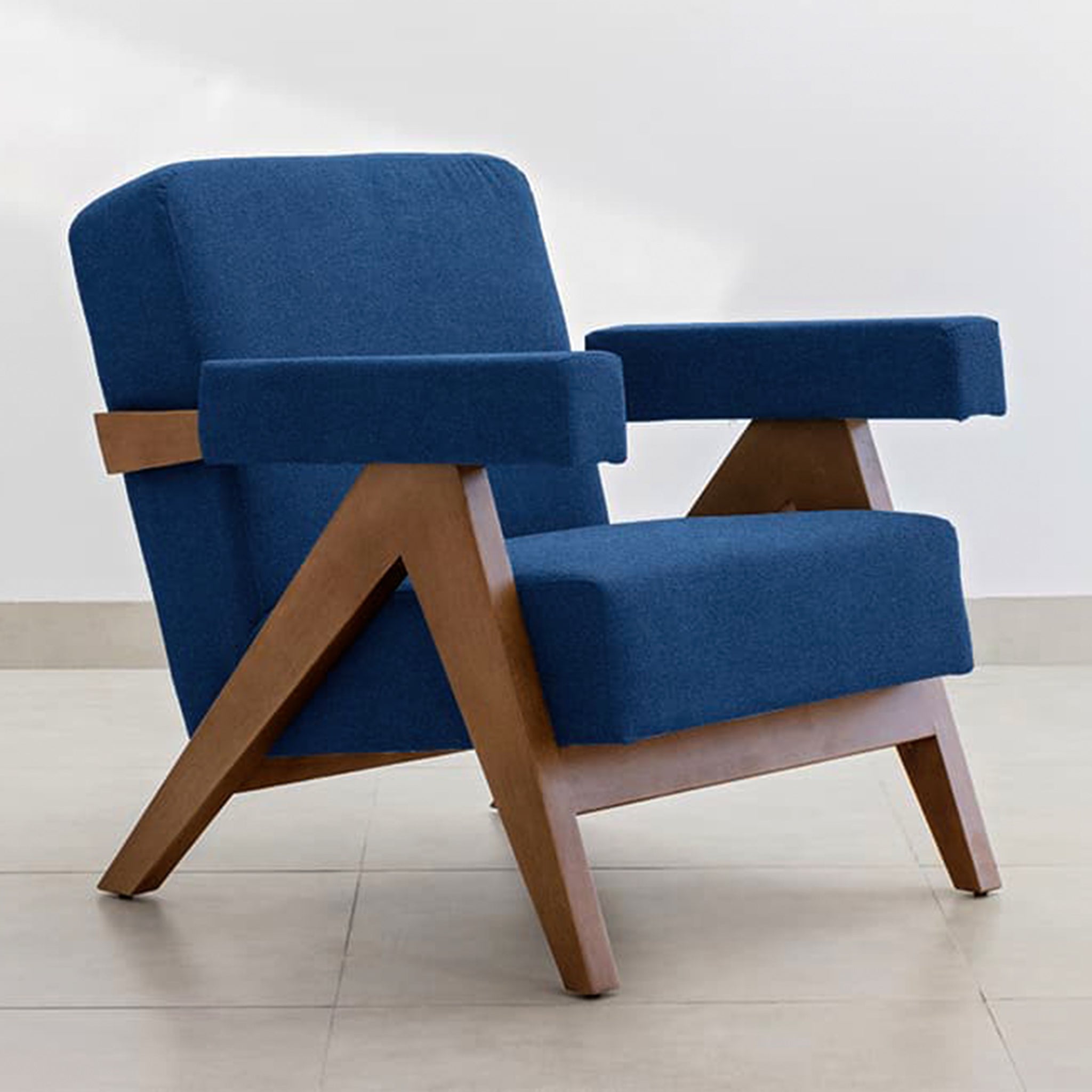 The Pierre Accent Chair with comfortable teal cushions and wooden arms.