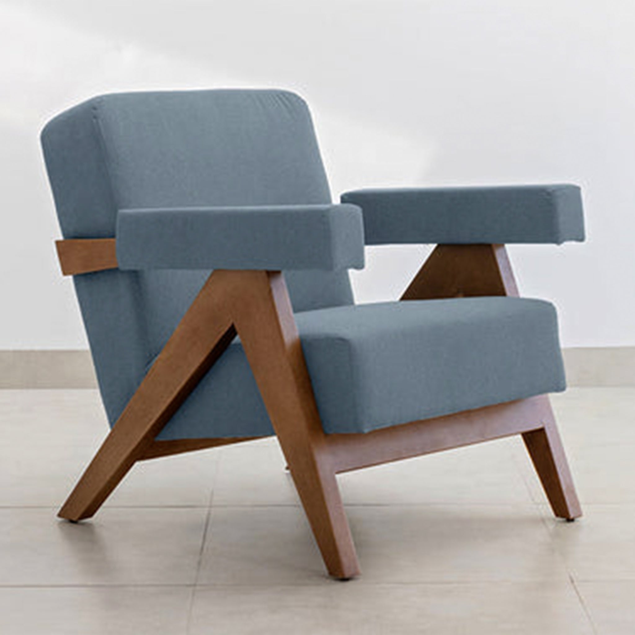 The Pierre Accent Chair featuring elegant teal fabric and a wooden frame.