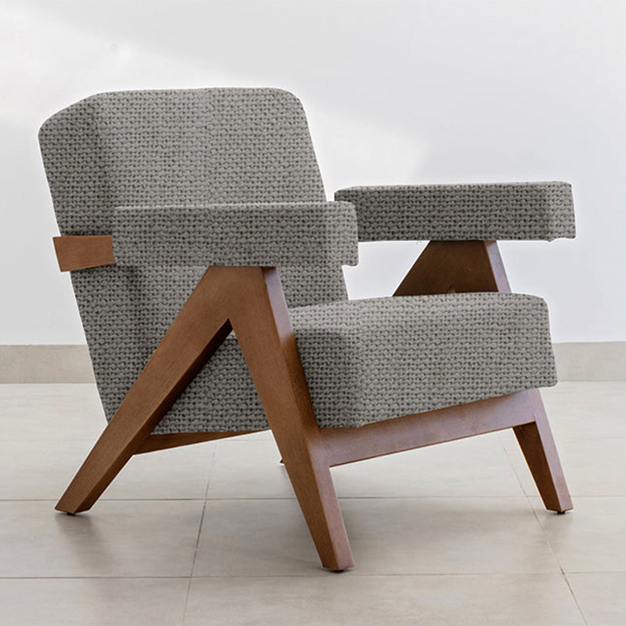 "Elegant and contemporary The Pierre Accent Chair with a wooden base."