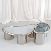 The Willow Chrome Coffee Table With Small Gestures enhances cozy living spaces with its modern design and reflective chrome accents.