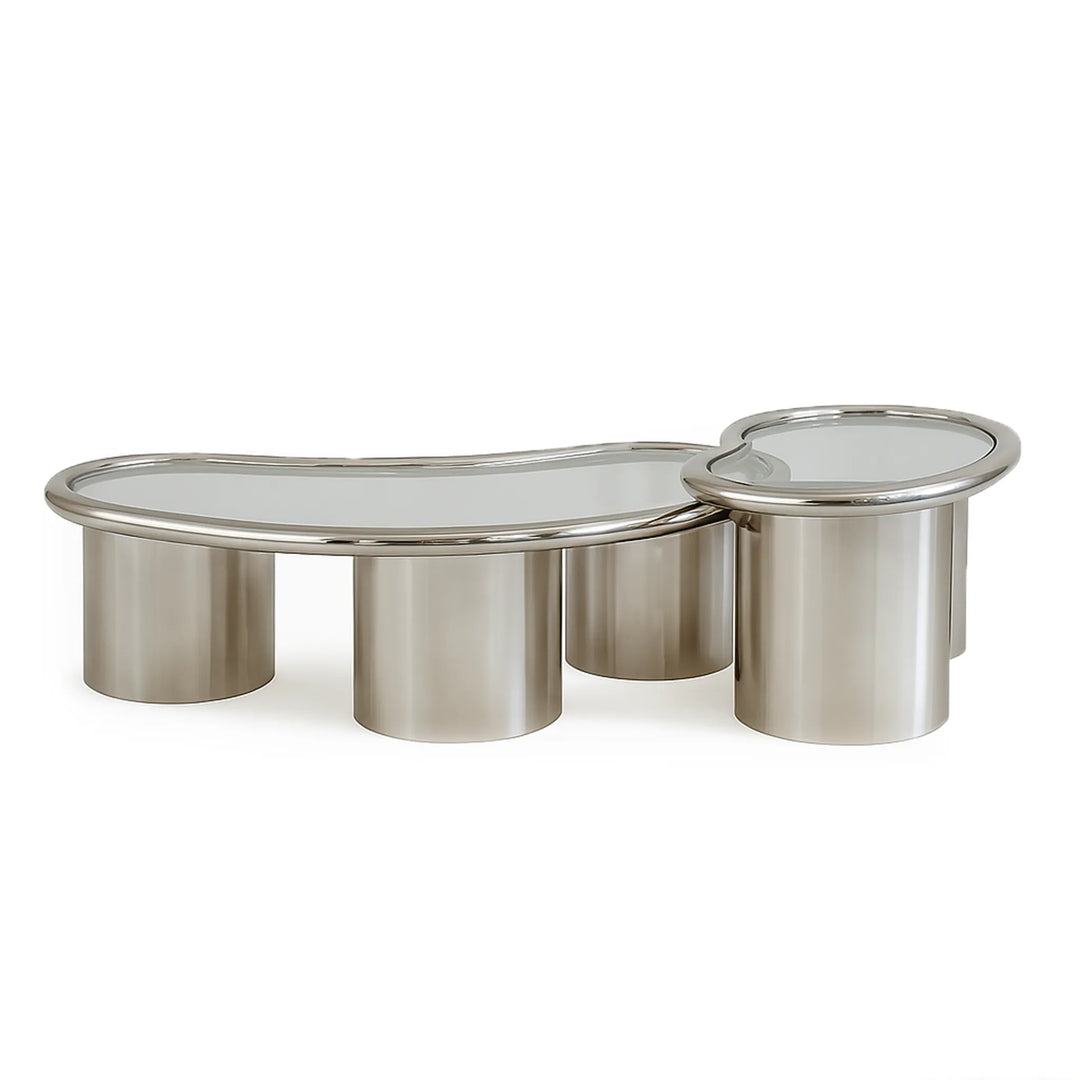 The Willow Chrome Coffee Table With Small Gestures stands out against a grey backdrop, highlighting its sleek chrome and glass design.