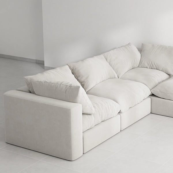 Luxury L shape sofa set with ottoman, highlighted on a grey background for a modern look.