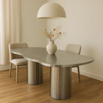Load image into Gallery viewer, The Victoria stainless steel dining table with a unique curvy design, adding a touch of modern elegance to your home.
