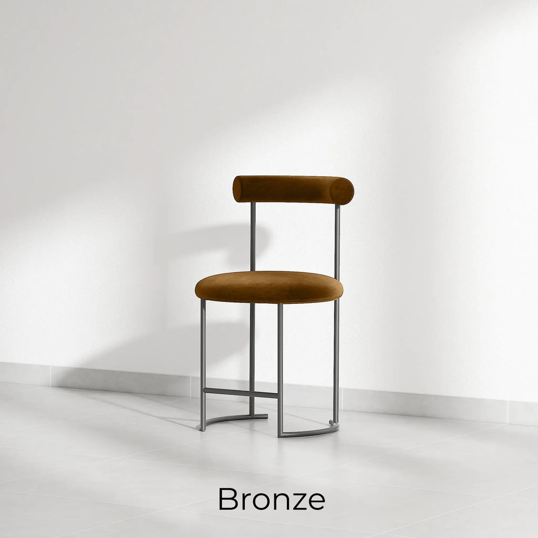 The Claudia round dining chair with soft upholstery, providing a comfortable seating experience for long meals.