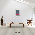 Load image into Gallery viewer, Lifestyle shot of The Edith Curvy Wood Coffee Table in honey, adding warmth and elegance to your living room.
