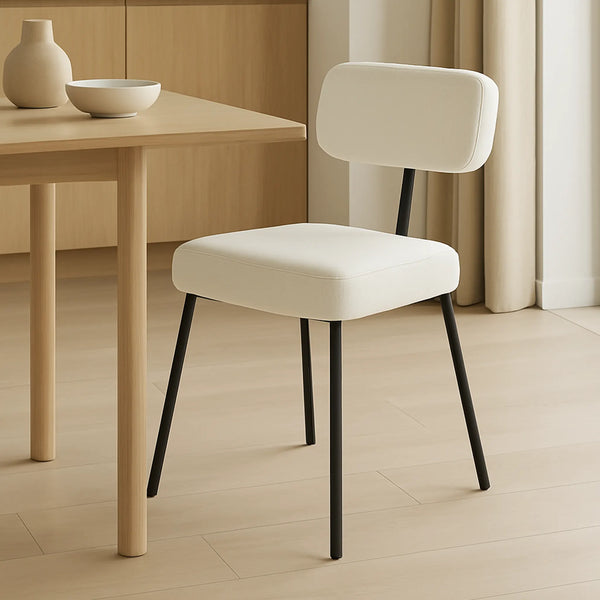The Ida polar fabric chair styled in a chic dining room, offering luxurious comfort and modern aesthetics.