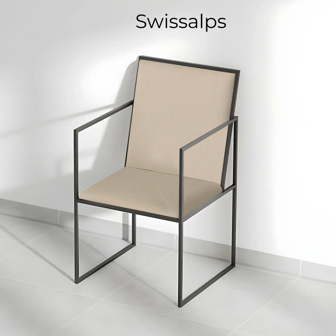 The Joelle dining chair with iron legs, bringing modern elegance to a beautifully set dining area.