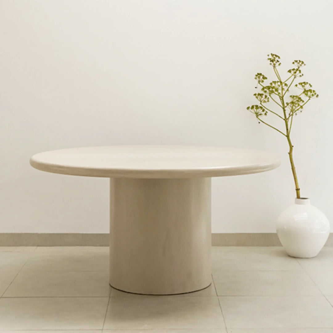 The Marx Microplaster round dining table styled in a contemporary dining room, offering both elegance and function.
