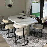The Victoria 6 seater dining table styled in a contemporary dining room, offering a luxurious and curvy design.
