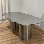 Load image into Gallery viewer, Sleek and modern steel dining table in stainless steel, paired with elegant chairs for a luxurious dining room.
