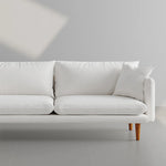 Load image into Gallery viewer, The Robin premium sofa styled in a minimalist home, offering timeless elegance.
