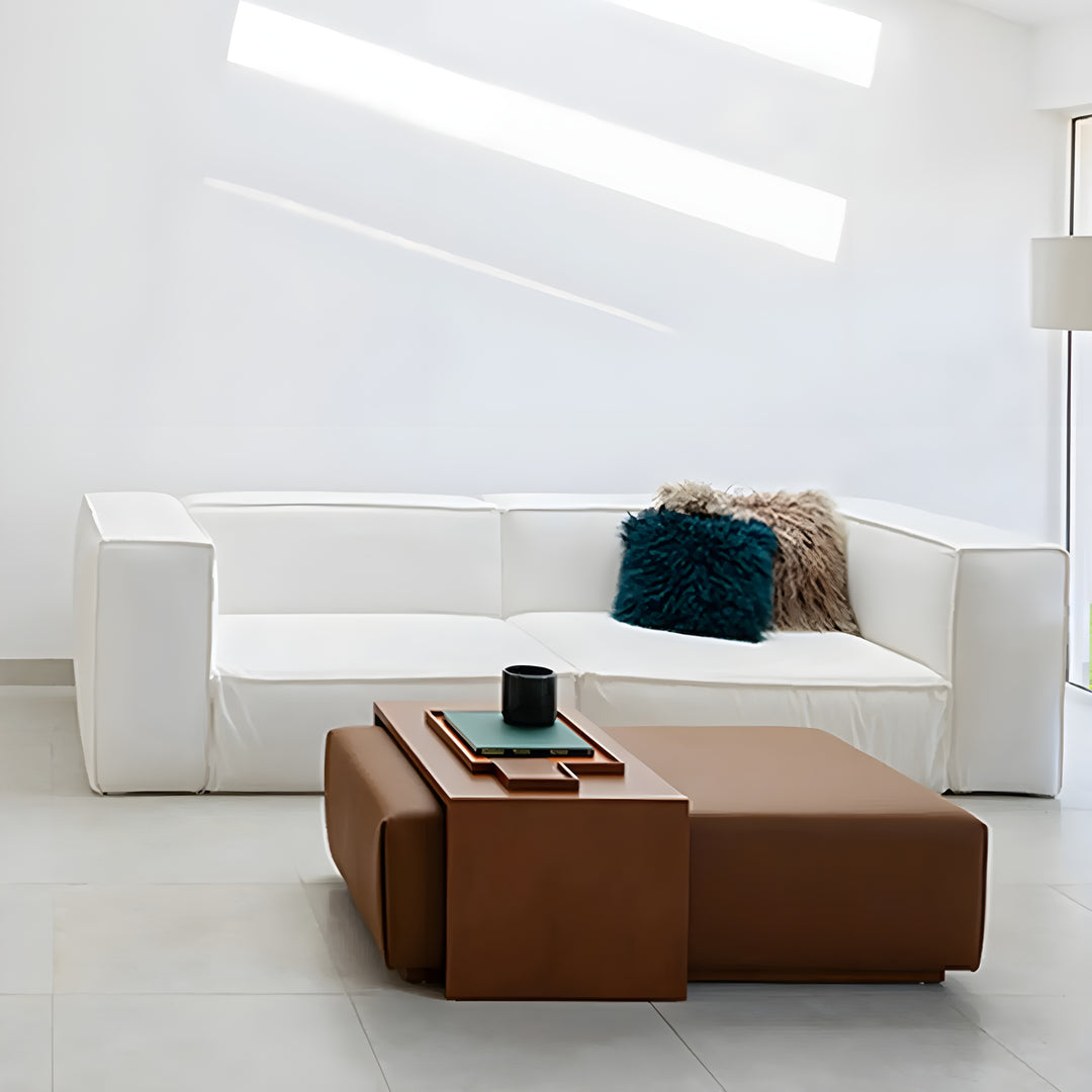 Lifestyle view featuring Sebastian Coffee Table and Italian ottoman in contemporary living room with sofa.